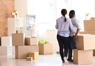 A couple surrounded by packed boxes getting ready for a move
