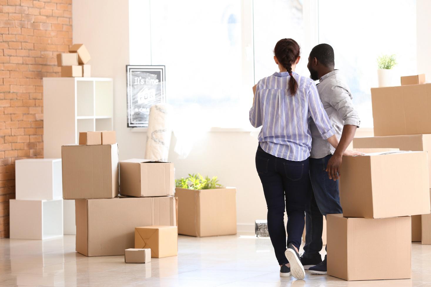 A couple surrounded by packed boxes getting ready for a move