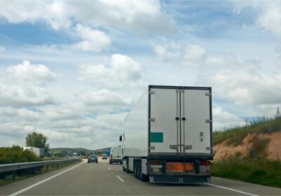 Long-distance moving truck transporting goods along a highway in Canada.