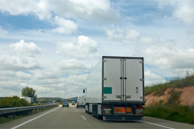 Long-distance moving truck transporting goods along a highway in Canada.